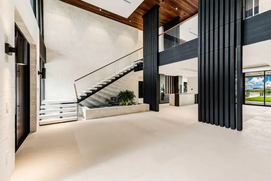 Foyer staircase with a glass rail